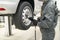 Tire service. Mechanic attaches the wheel to the car