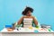 Tired african american student guy having nap on books, being exhausted during preparing for exams, blue background