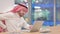 Tired Arab Businessman with Laptop having Back Pain in Office