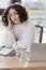 Tired arabian businesswoman sitting near clipboard