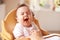 Tired Baby In High Chair At Meal Time