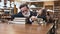 Tired bearded senior man and his teen pretty granddaughter sleeping on books in the library