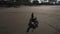 Tired biker having rest on an evening ocean beach