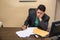 Tired bored young businessman sitting in office