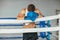 Tired boxer resting in boxing ring