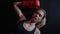 Tired boxer woman is lying down after hard training in boxing gym, wearing sport clothes and red boxing gloves. Female