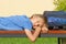 Tired boy relaxing after school. Boy lying with closed eyes on the bench