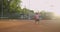 A tired brunette female tennis player walks along the tennis court recuperating and concentrating. Break in a tennis