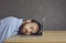 Tired business man office worker sleeping on laptop keyboard studio shot