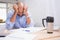 Tired businessman with paperwork at desk