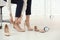 Tired businesswoman changing shoes at workplace in office