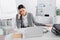 Tired businesswoman sitting near calculator, papers