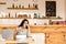 Tired cafe owner holding glasses near calculator, papers and laptop