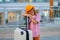 Tired child traveller. Portrait of child traveler with travel bag. Little tourist with suitcase ready to travelling.