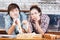 Tired couple with flour on faces kneading dough at kitchen