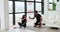 Tired couple sitting on floor and drinking water after workout