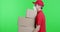 Tired delivery guy in protective mask carrying heavy boxes