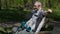 Tired disabled man with crutches on bench in the park