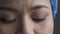Tired doctor eyes. Beautiful eyes of a female health worker looking down wearily. Super Close up shot. Selective focus