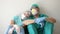 Tired doctor and nurse are resting sitting on the floor in a hospital corridor.