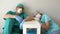 Tired doctor and nurse are resting sitting on the floor in a hospital corridor.