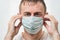 Tired doctor in protective face mask prevent virus infection. Portrait close up