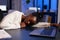 Tired exhausted african american businesswoman sleeping on desk table