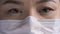 Tired female doctor eyes. Eyes of Asian woman in safety mask looks at camera. Close up shot