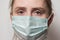 Tired female doctor in surgical mask styryl. Portrait close up. Health care and medical concept