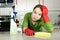 Tired girl cleaning kitchen