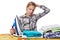 Tired girl with washed linen around ironing board and iron isolated