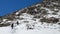 Tired group of climbers descent from the snow mountain in winter day. Long shoot