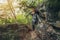 Tired hiker woman climbing up in forest