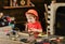 Tired kid playing in workshop. Small boy hammering nail. Little child in orange helmet sitiing at working desk