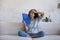 Tired Latin woman waving paper handheld fan for cooling air