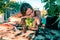 Tired latin young woman transplanting plants and flowers