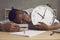 Tired or lazy black student sleeping at his desk not knowing he& x27;s late for class