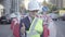 Tired little boy in constructor helmet on his head, and uniform looking in camera showing thumb up. Architect concept