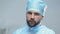 Tired male surgeon in protective uniform, medical profession, qualified doctor