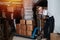 Tired male warehouse distribution worker resting with boxes on a cart