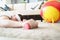 Tired man laying on carpet floor with dumbbell equipment in hand