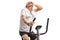 Tired mature man riding an exercise bike