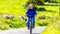 Tired mature Mexican woman driving her bicycle on a hill