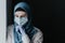 Tired medical worker doctor woman muslim woman in hijab after taking a large number of patients due to epidemic of coronavirus