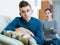 Tired mother rebuking teenage son at home