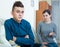 Tired mother rebuking teenage son at home