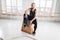 Tired muscular man sitting on box in crossfit gym