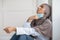 Tired muslim woman doctor removing protective face mask