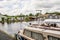 Tired old residential boat moored up on the River Bure in the village of Wroxham, Norfolk