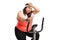 Tired overweight woman exercising on a cross-trainer machine